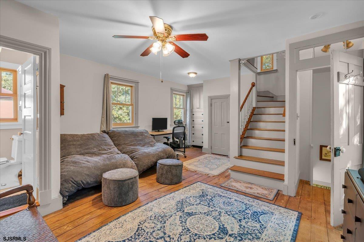 56 Main Street Port Republic, NJ 08241 - Photo 31 of 44 a living room with furniture a rug and a chandelier