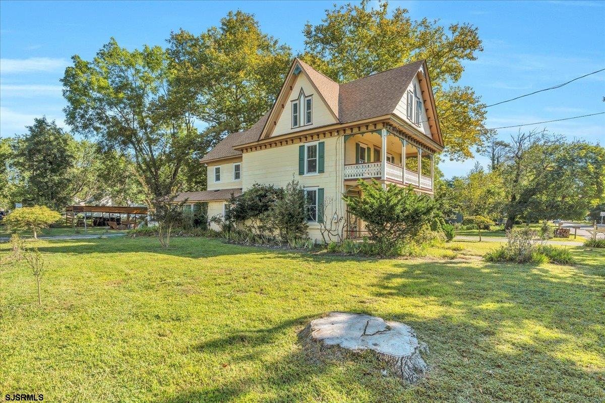 56 Main Street Port Republic, NJ 08241 - Photo 4 of 44 a front view of house with yard and trees around