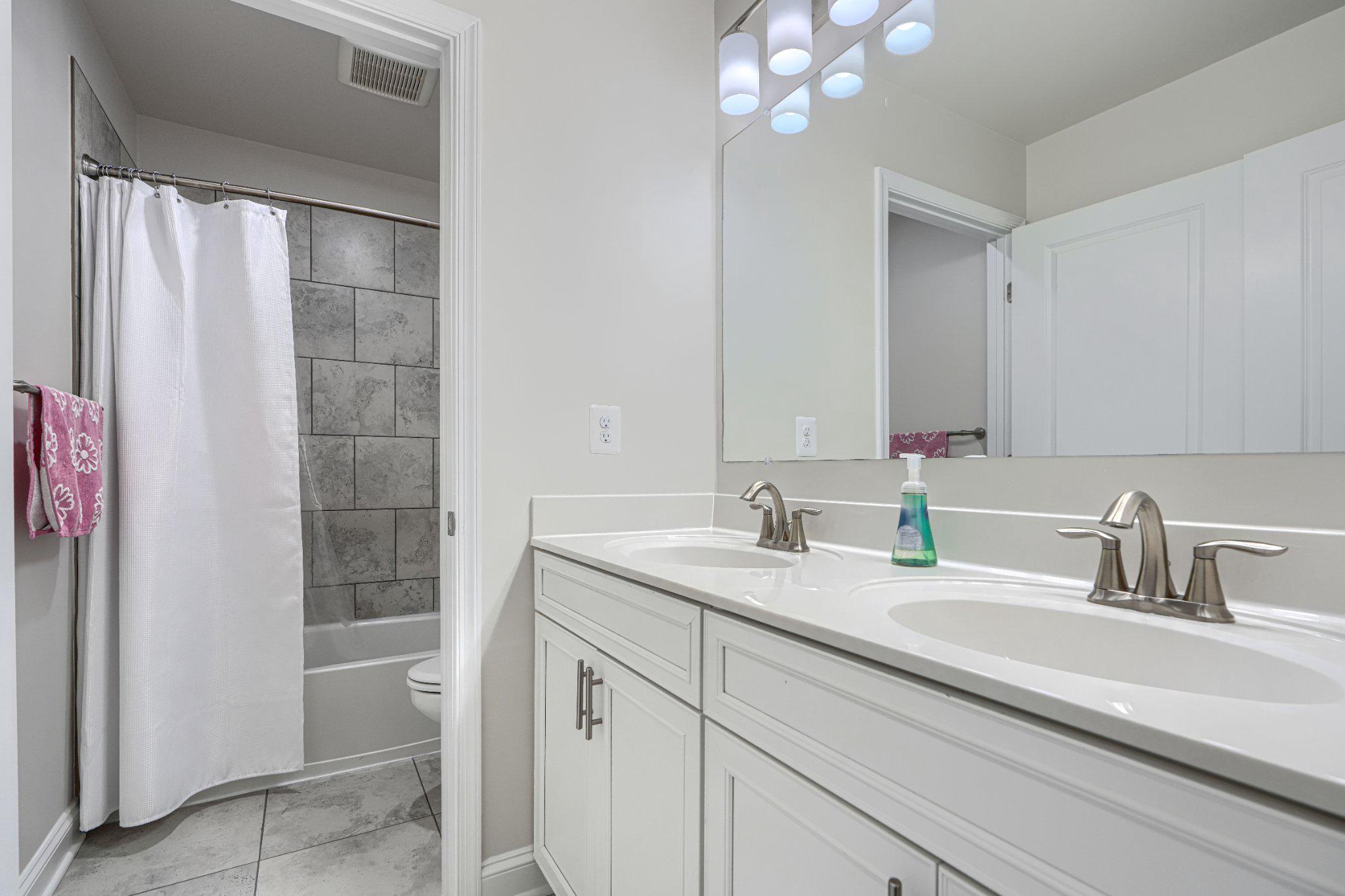 2707 Lady Slipper Road Gambrills, MD 21054 - Photo 30 of 60 a bathroom with a sink double vanity and a mirror