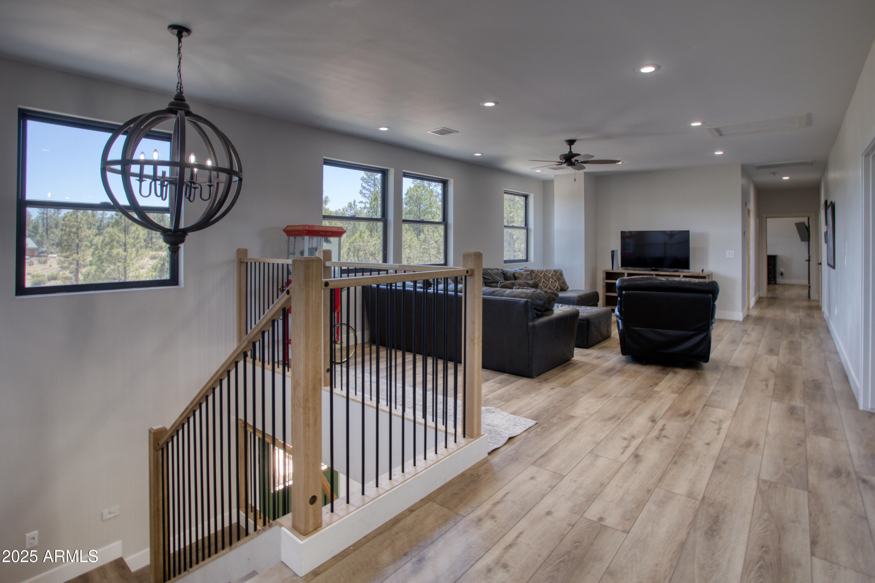 1850 Pinecone Heber, AZ 85928 - Photo 11 of 40 a view of a livingroom with furniture wooden floor windows and a chandelier