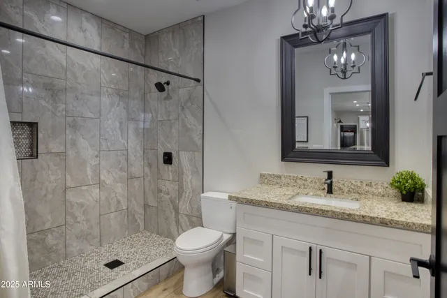 a view of a livingroom with wooden floor and a flat screen tv
