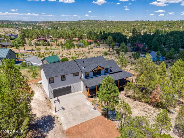 an aerial view of a house with a yard and lake view