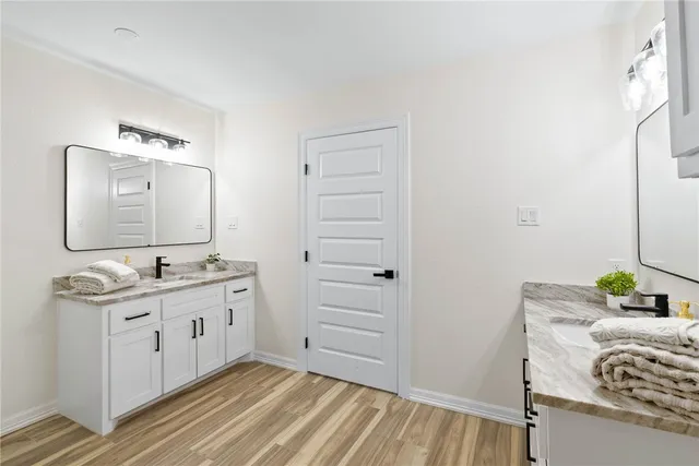 a bathroom with a sink a mirror and a