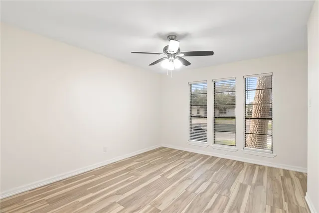 wooden floor in an empty room with a window