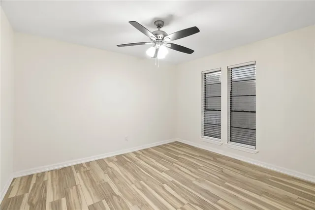 a view of a room with window and ceiling fan