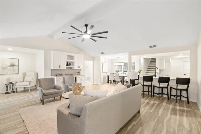 a living room with furniture wooden floor and a view of kitchen