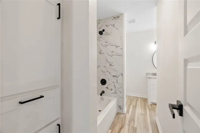 a bathroom with a bathtub and shower