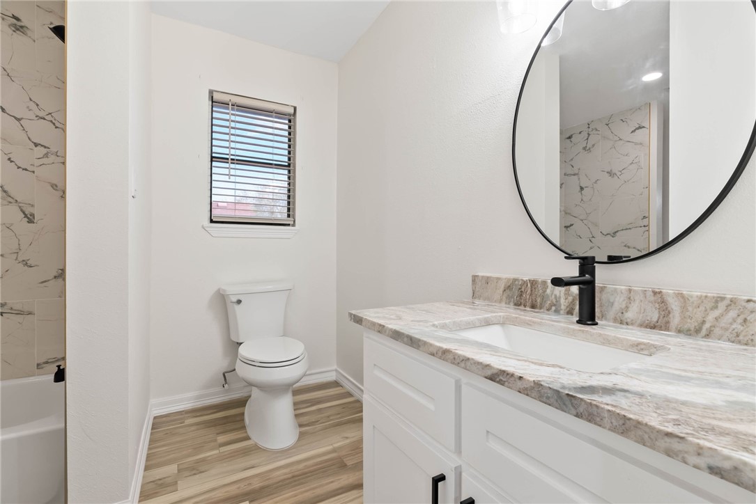 1906 Oak Ridge Drive Portland, TX 78374 - Photo 9 of 20 a bathroom with a toilet sink and mirror