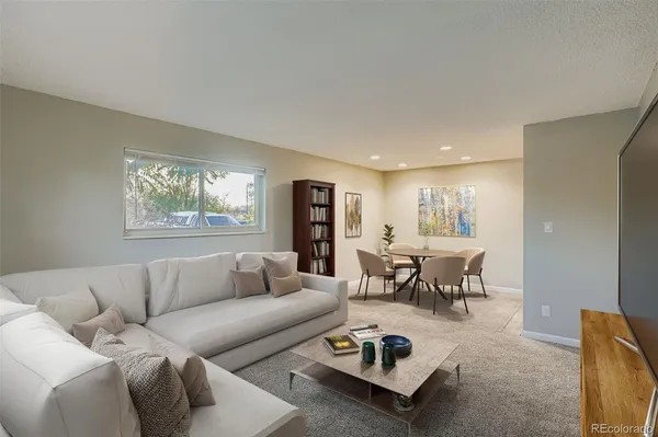 a living room with furniture wooden floor and a table
