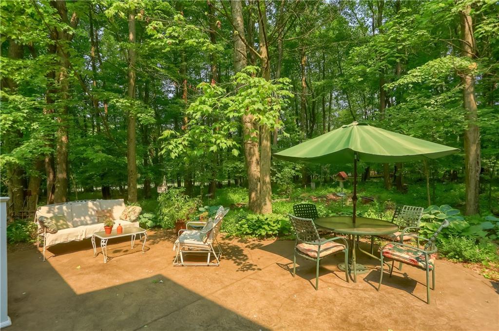 206 Reiber Road Renfrew, PA 16053 - Photo 38 of 43 a view of a table and chairs under an umbrella in backyard
