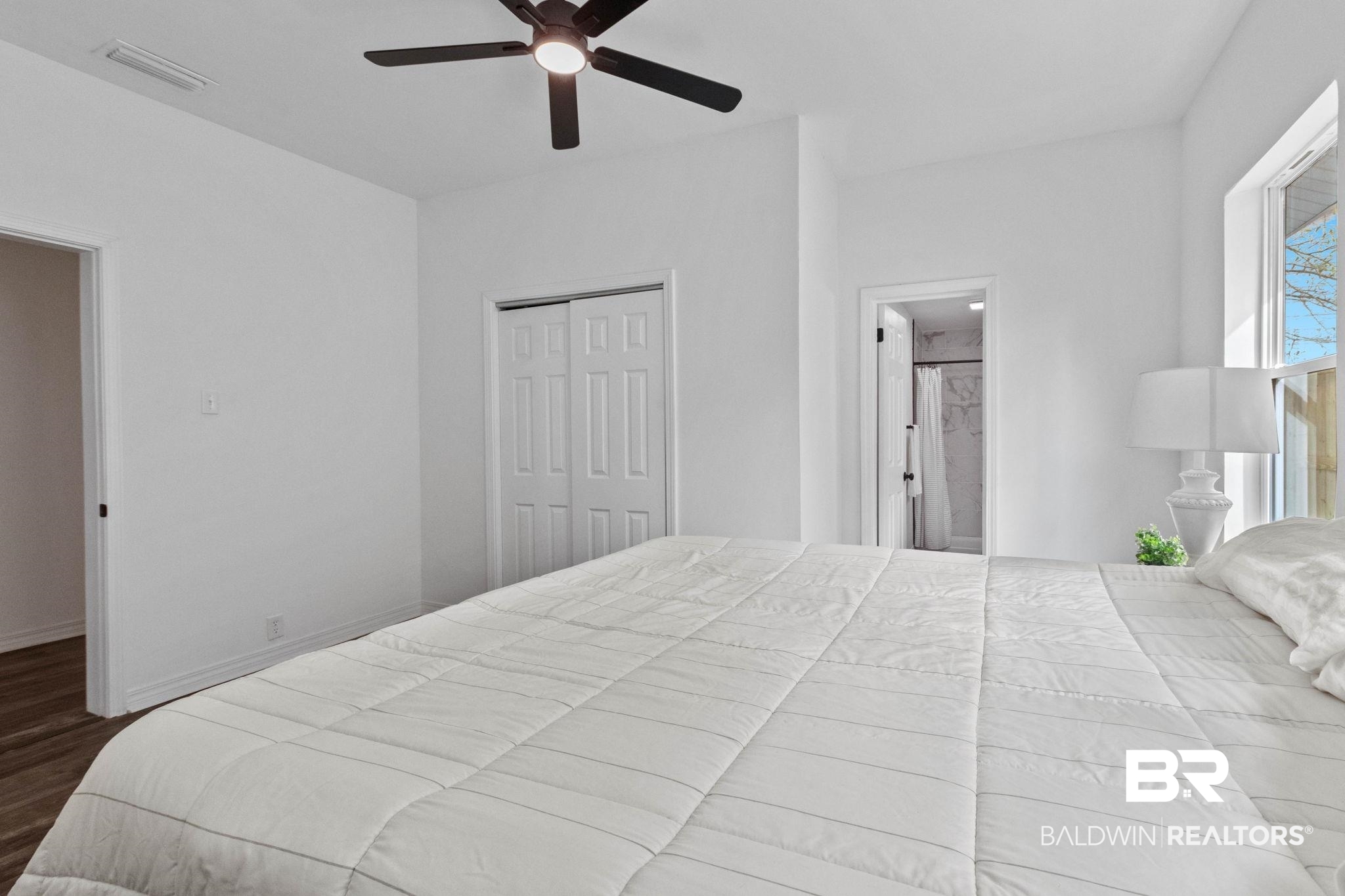 128 Bush Avenue Mobile, AL 36604 - Photo 21 of 40 Bedroom featuring a ceiling fan, a closet, and dark wood-type flooring