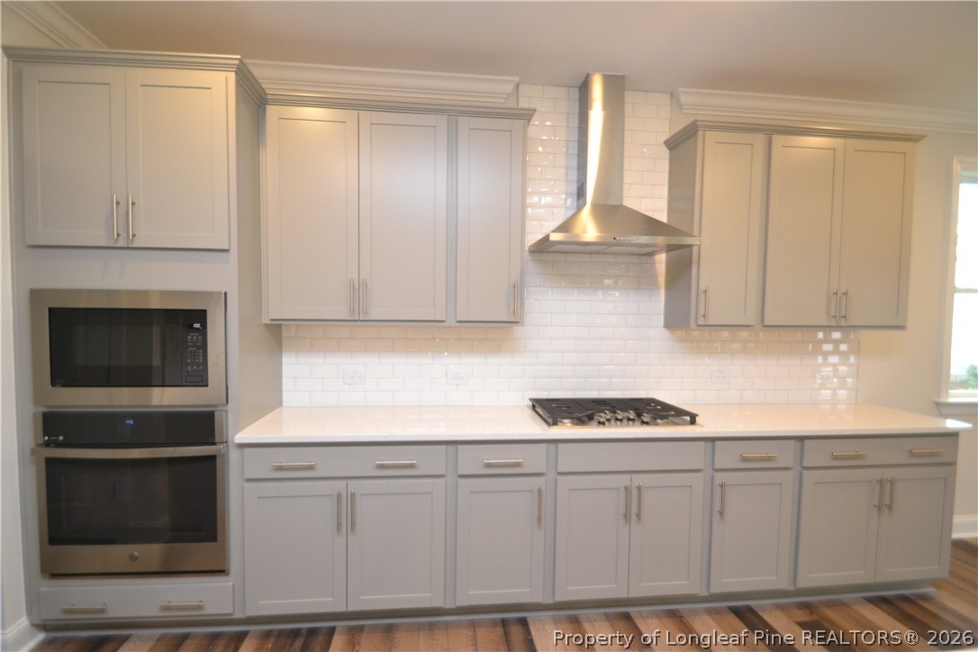 421 Canyon Spring Trail Wake Forest, NC 27587 - Photo 13 of 50 a kitchen with white cabinets and black appliances