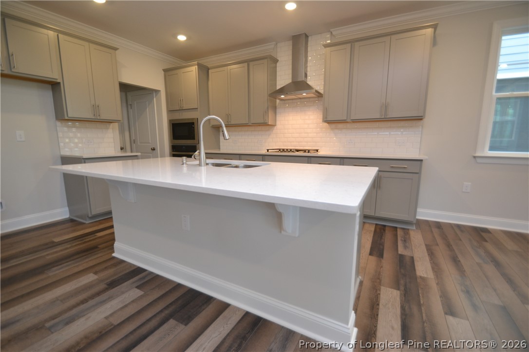 421 Canyon Spring Trail Wake Forest, NC 27587 - Photo 17 of 50 a kitchen with stainless steel appliances a sink stove and cabinets