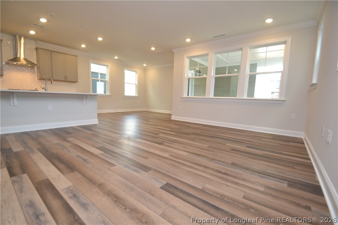 421 Canyon Spring Trail Wake Forest, NC 27587 - Photo 18 of 50 a view of an empty room with wooden floor and a window