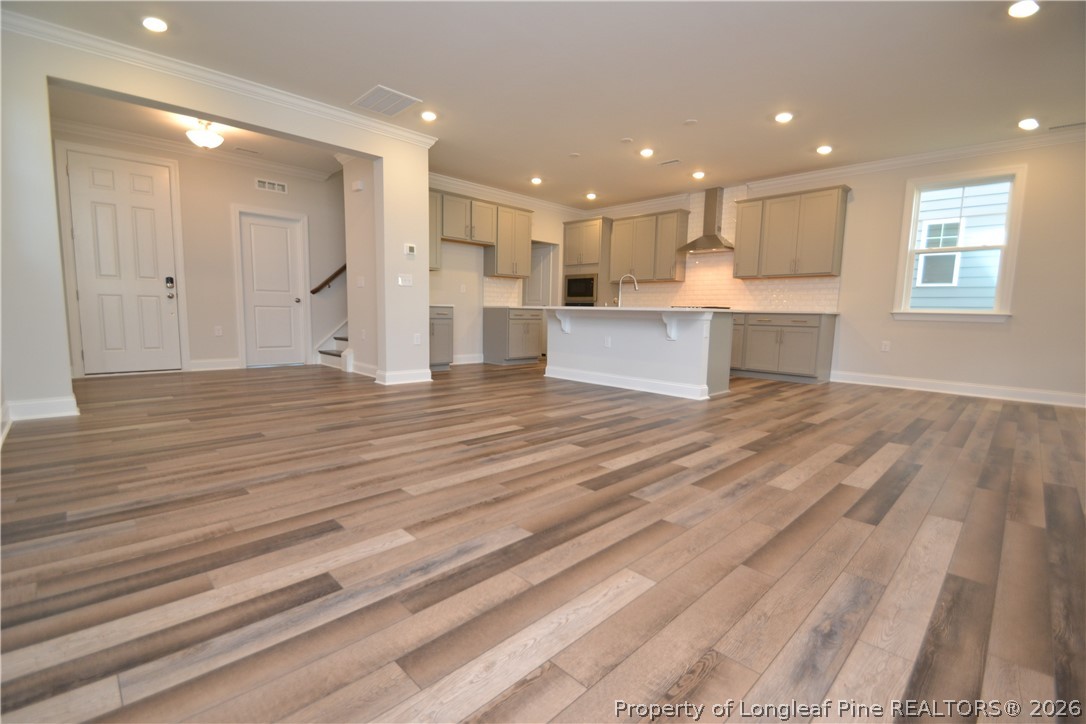 421 Canyon Spring Trail Wake Forest, NC 27587 - Photo 19 of 50 a view of kitchen with kitchen island granite countertop cabinets and wooden floor