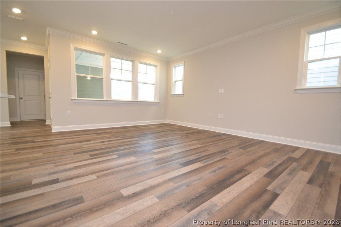 421 Canyon Spring Trail Wake Forest, NC 27587 - Photo 21 of 50 an empty room with wooden floor and windows