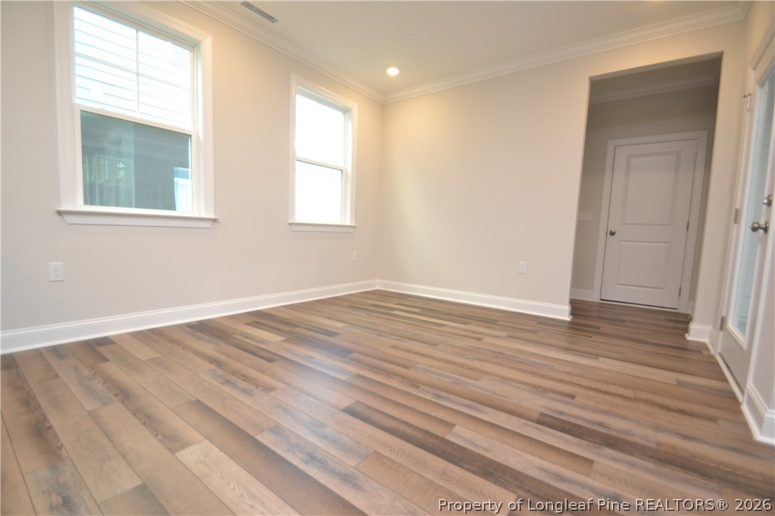 421 Canyon Spring Trail Wake Forest, NC 27587 - Photo 22 of 50 a view of an empty room with wooden floor and a window