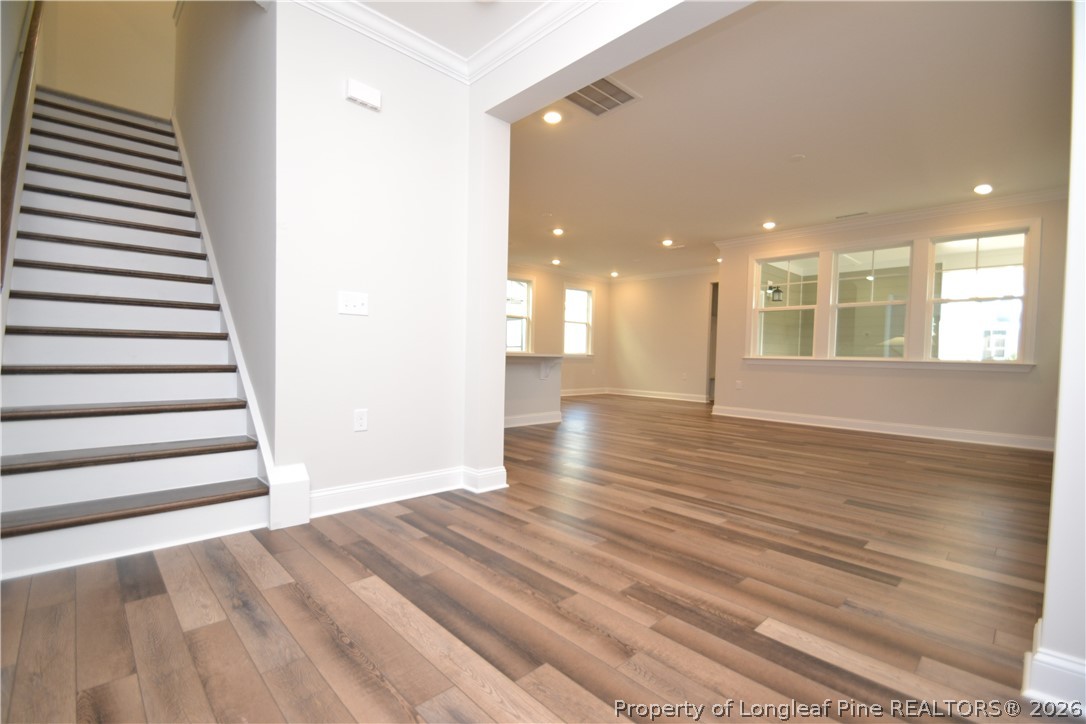 421 Canyon Spring Trail Wake Forest, NC 27587 - Photo 3 of 50 a view of an empty room with wooden floor and windows