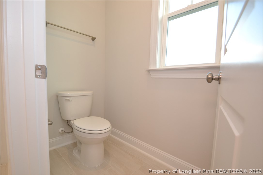 421 Canyon Spring Trail Wake Forest, NC 27587 - Photo 43 of 50 a white toilet sitting in a bathroom next to a window