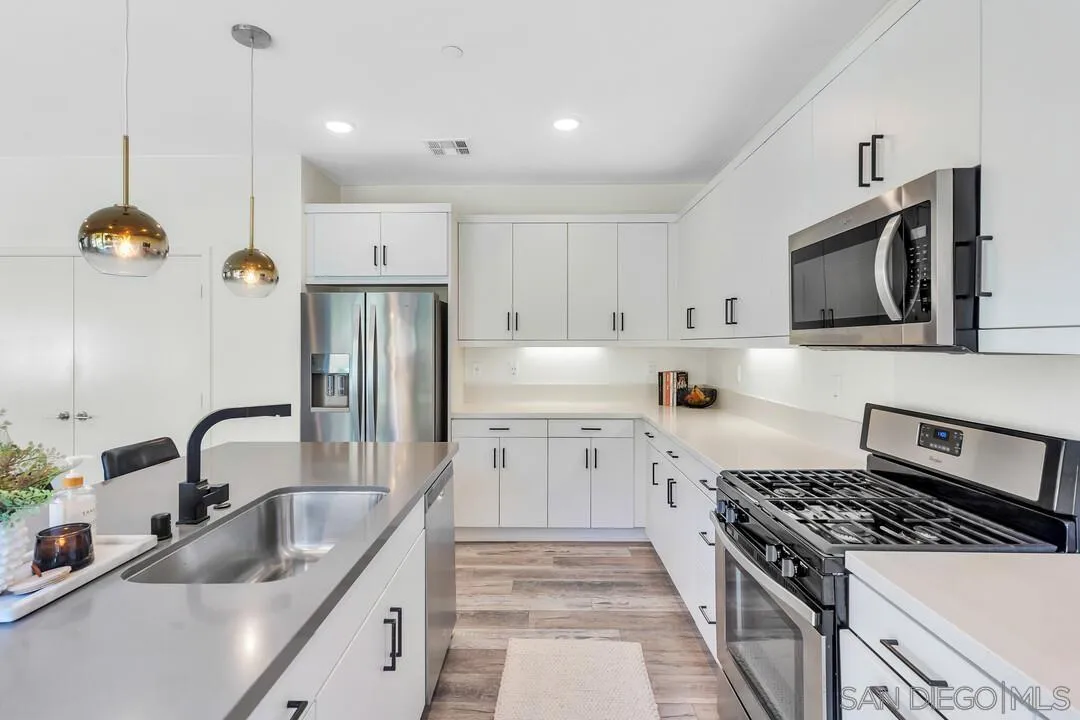 8844 Weston Road Santee, CA 92071 - Photo 14 of 48 a kitchen with stainless steel appliances granite countertop a sink stove and refrigerator
