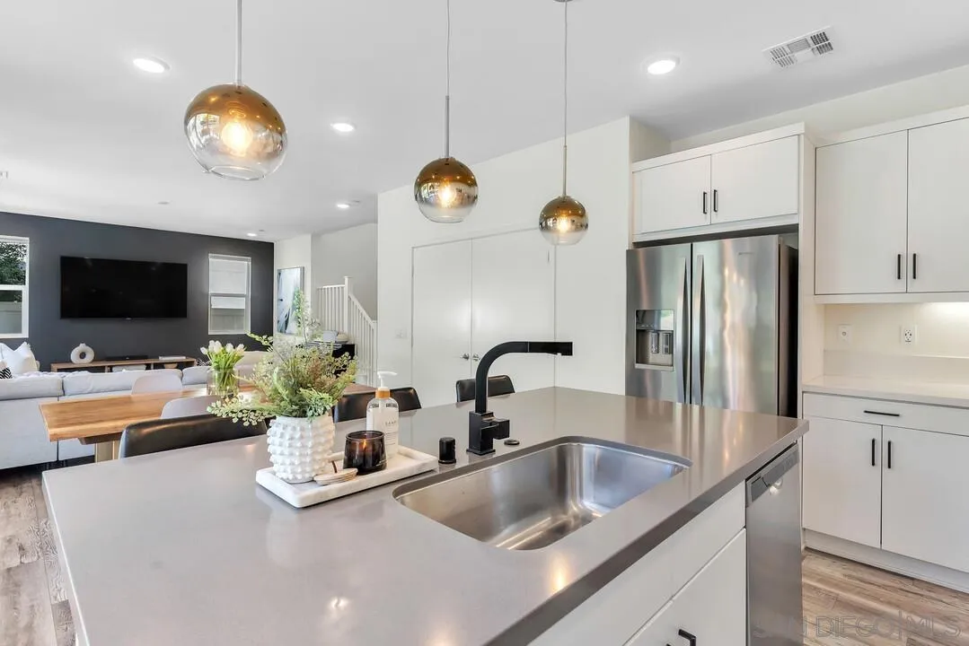 8844 Weston Road Santee, CA 92071 - Photo 15 of 48 a kitchen with stainless steel appliances granite countertop a sink a stove and a wooden cabinets