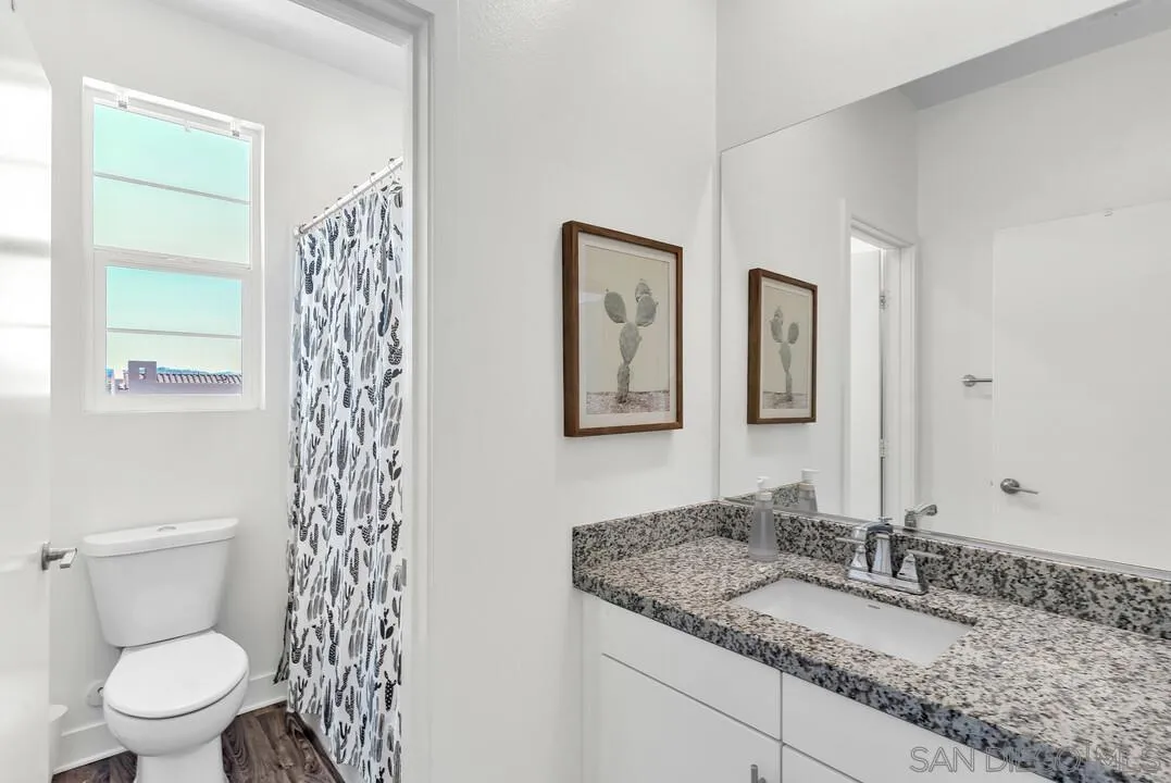 8844 Weston Road Santee, CA 92071 - Photo 22 of 48 a bathroom with a granite countertop sink toilet and shower