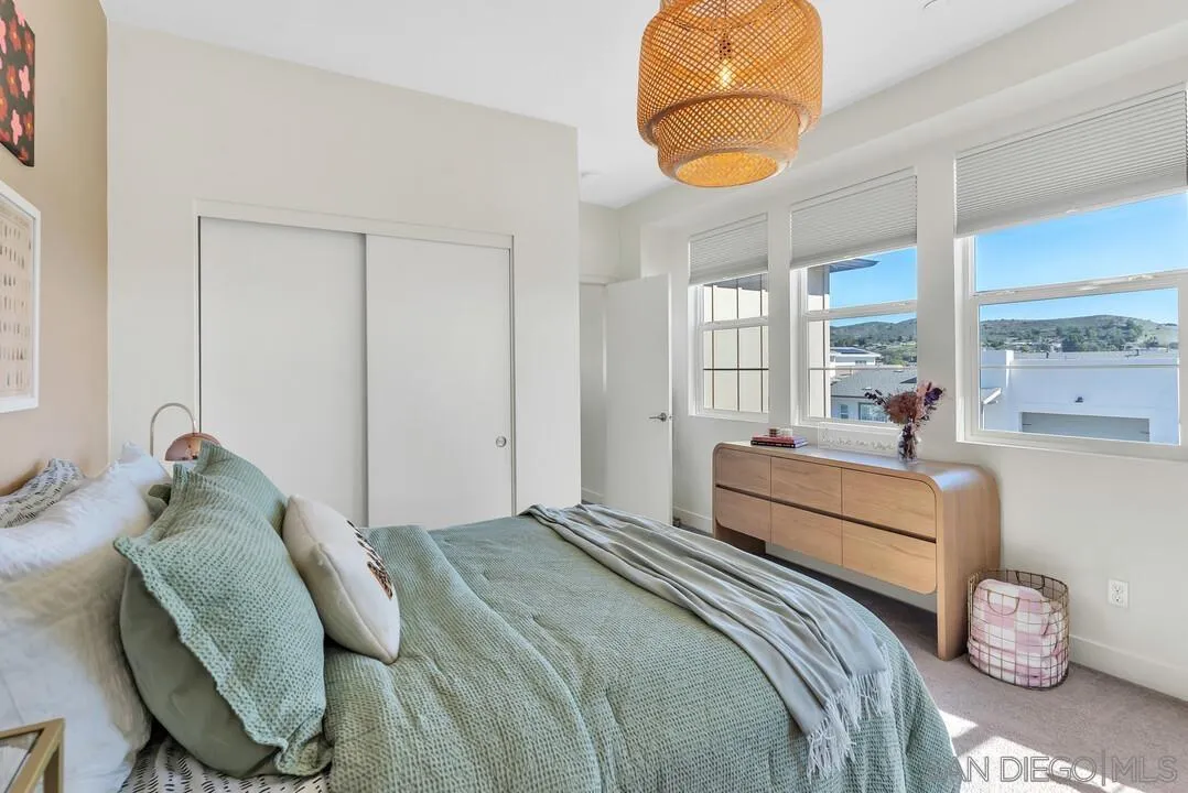 8844 Weston Road Santee, CA 92071 - Photo 24 of 48 a bedroom with a bed a window and potted plant