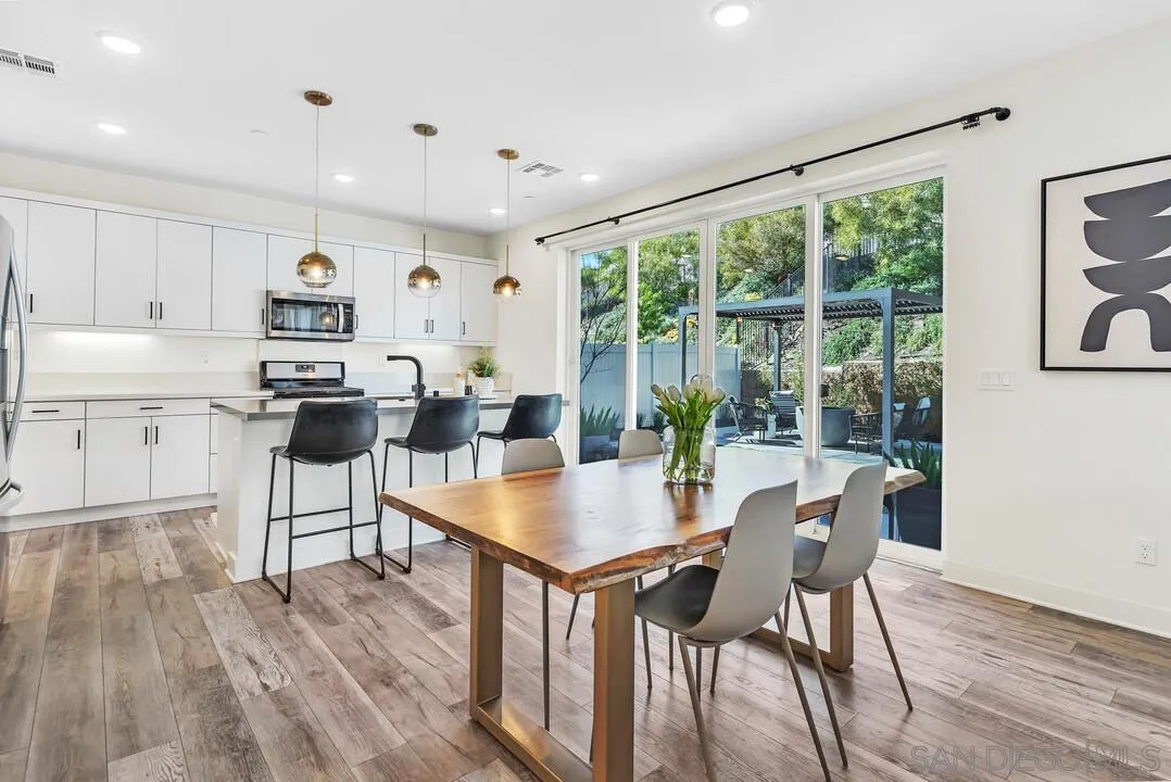 8844 Weston Road Santee, CA 92071 - Photo 9 of 48 a living room with stainless steel appliances furniture a large window and wooden floor