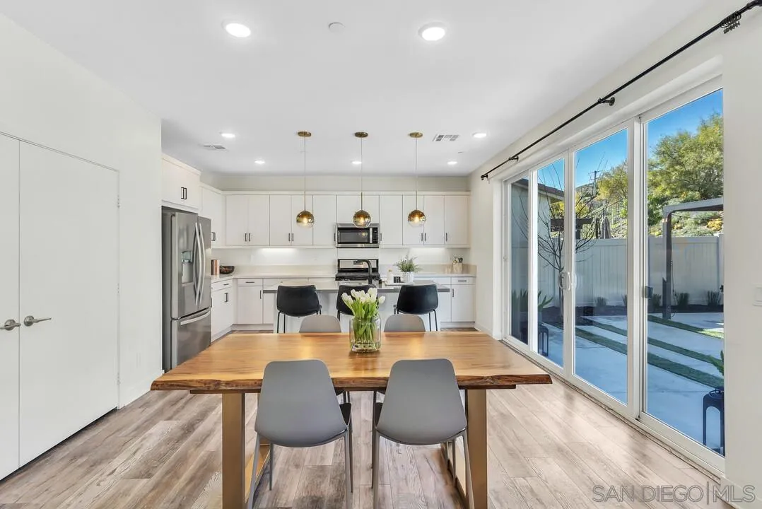 8844 Weston Road Santee, CA 92071 - Photo 10 of 48 a view of a dining room with furniture large window and wooden floor
