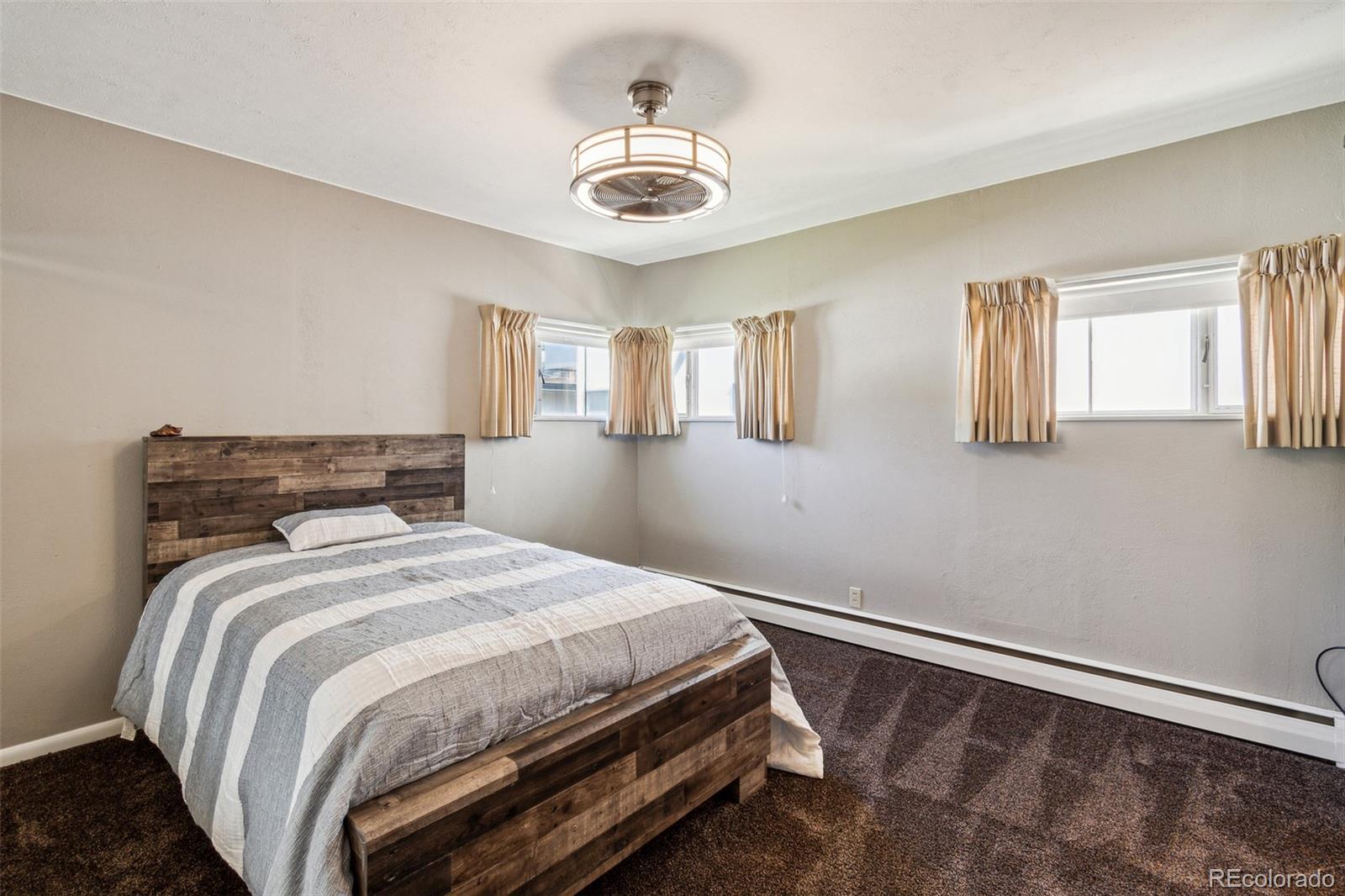 2435 South Race Street Denver, CO 80210 - Photo 14 of 33 a bedroom with a bed and a chandelier