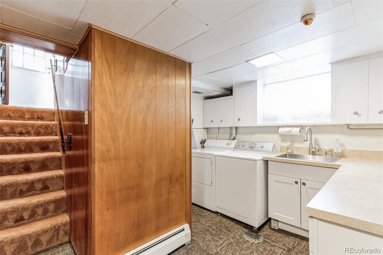 2435 South Race Street Denver, CO 80210 - Photo 21 of 33 a bathroom with a sink and a mirror