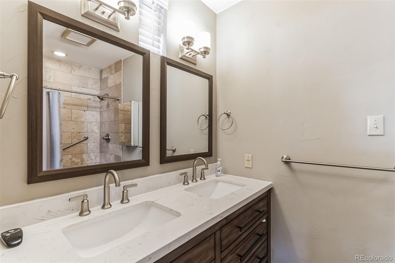 2435 South Race Street Denver, CO 80210 - Photo 23 of 33 a bathroom with a sink and a mirror
