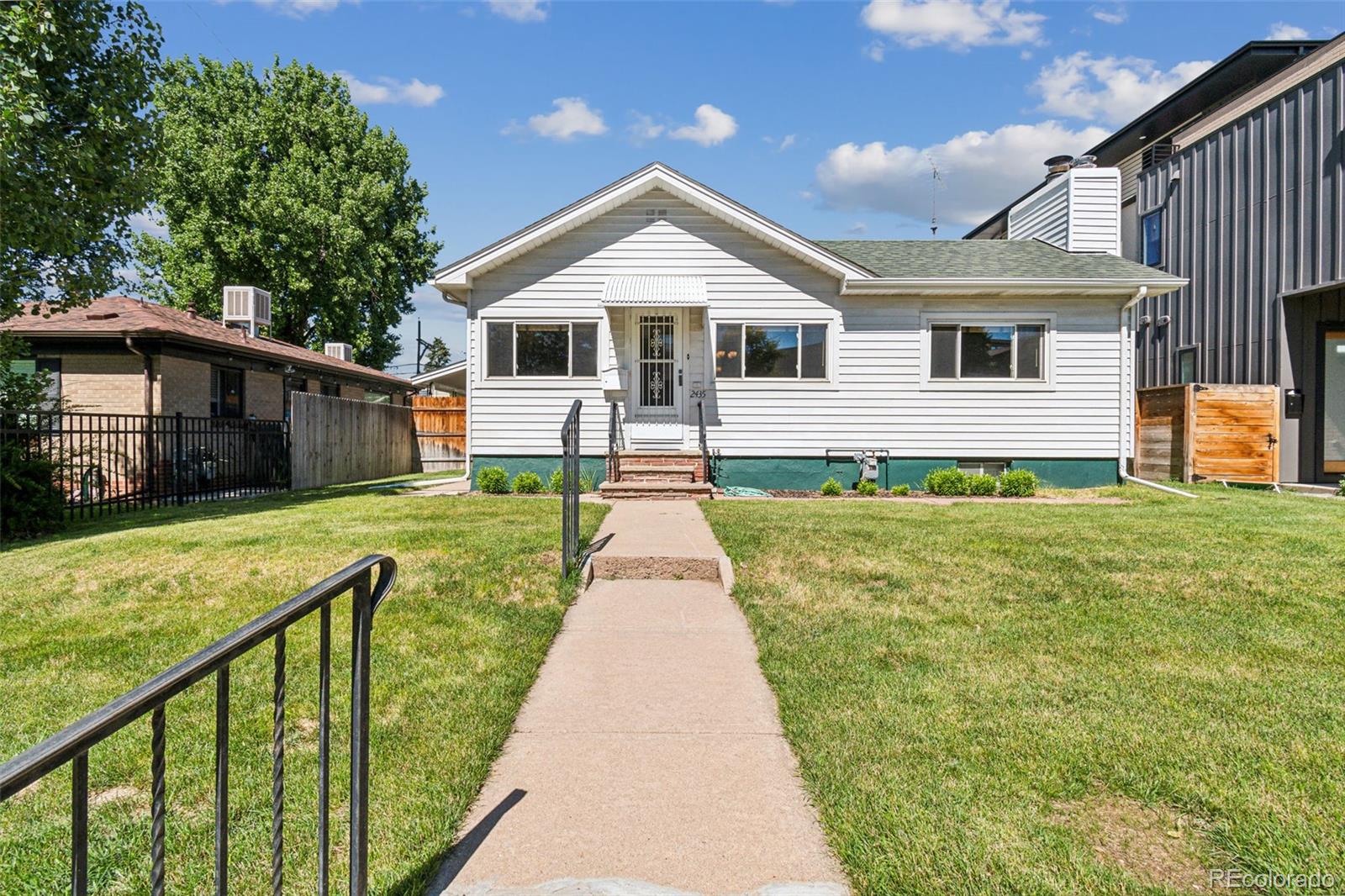 2435 South Race Street Denver, CO 80210 - Photo 26 of 33 a front view of a house with a yard balcony