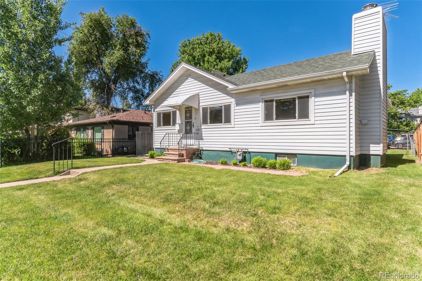 2435 South Race Street Denver, CO 80210 - Photo 29 of 33 a front view of a house with a yard