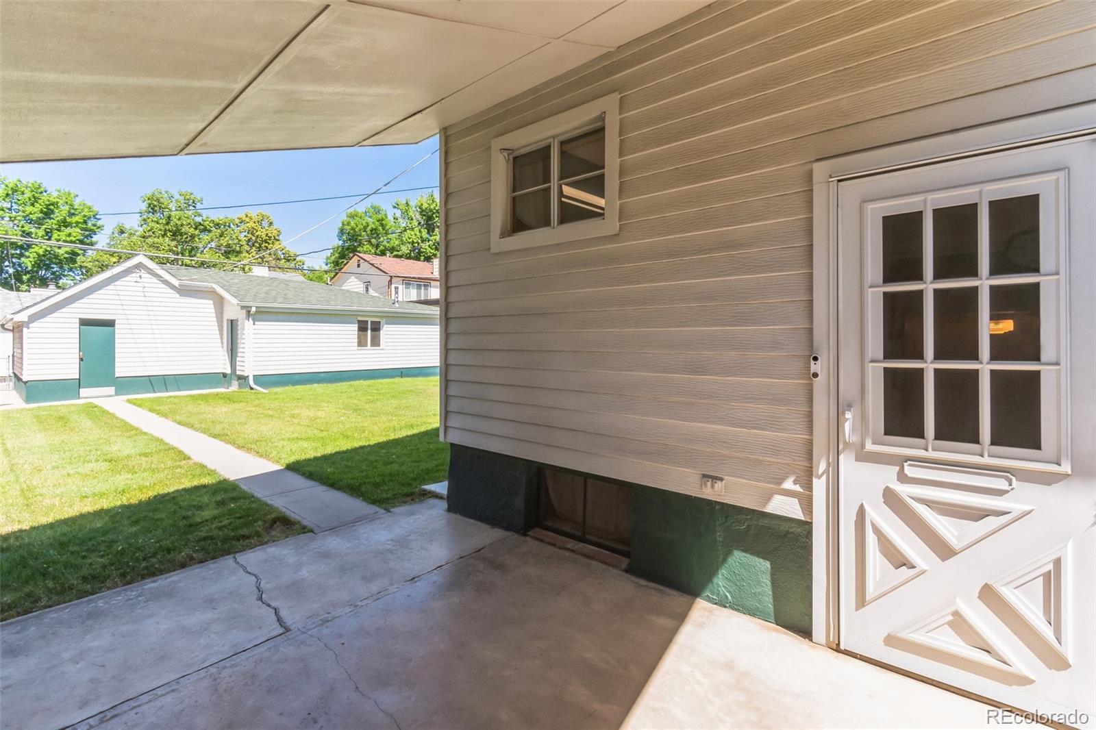 2435 South Race Street Denver, CO 80210 - Photo 31 of 33 a view of house with backyard space and tub