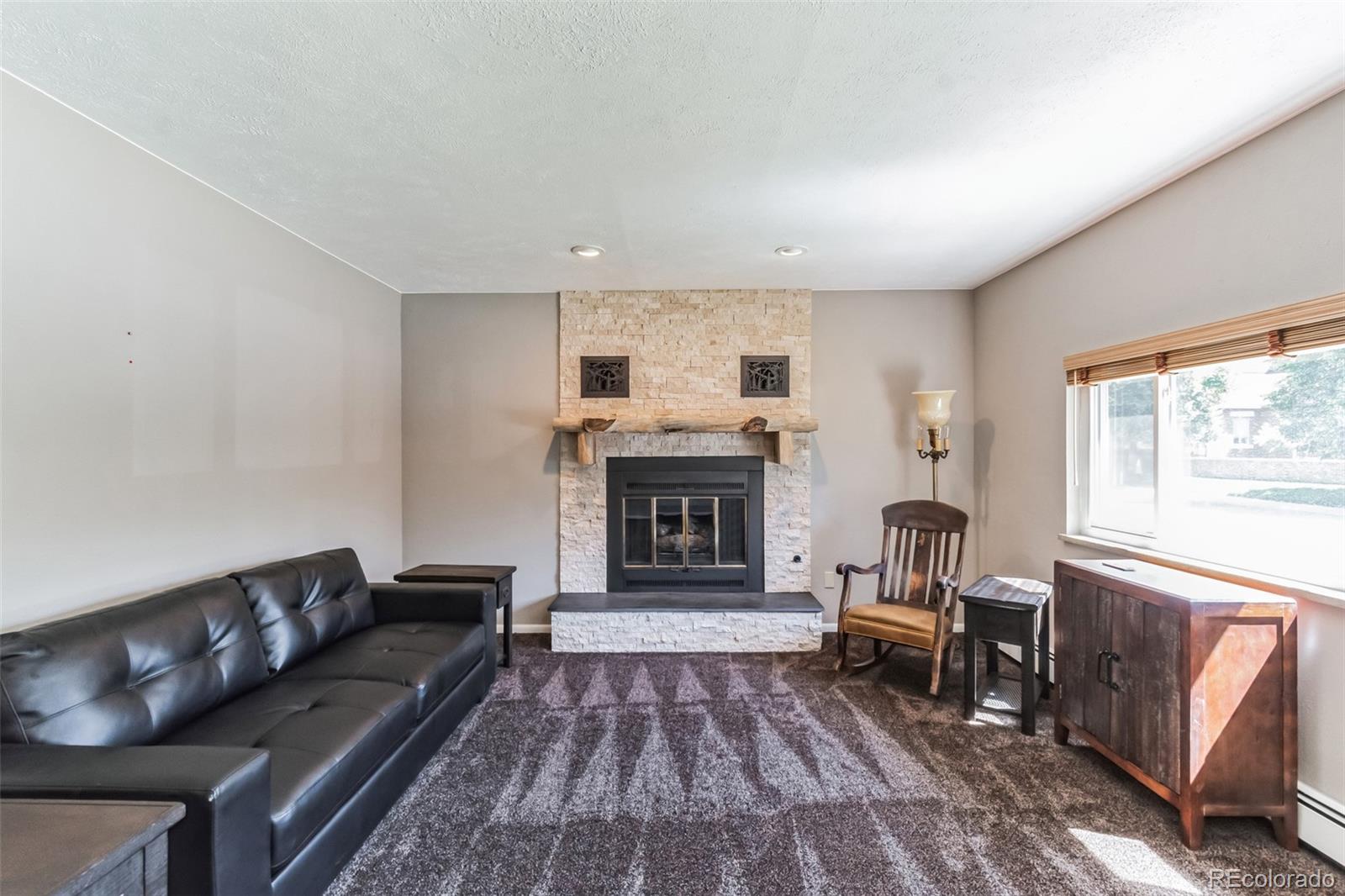 2435 South Race Street Denver, CO 80210 - Photo 4 of 33 a living room with furniture and a fireplace