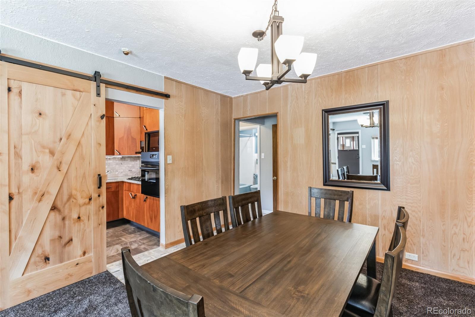 2435 South Race Street Denver, CO 80210 - Photo 7 of 33 a view of a dining room with furniture and a chandelier