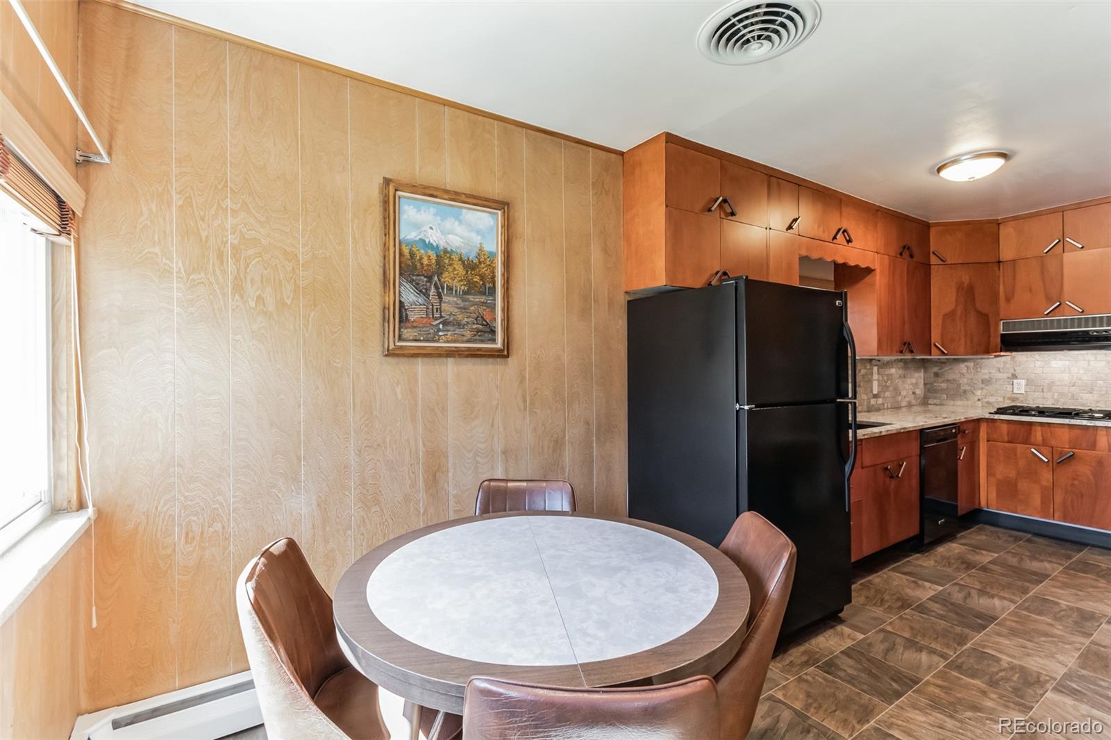 2435 South Race Street Denver, CO 80210 - Photo 10 of 33 a kitchen with stainless steel appliances a refrigerator and a stove
