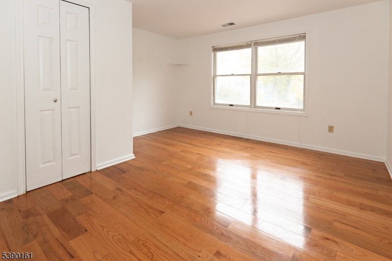 7 Emmet Avenue, Unit D Morristown, NJ 07960 - Photo 18 of 26 an empty room with wooden floor and windows
