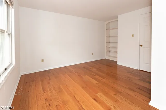 an empty room with wooden floor