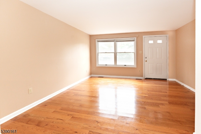 7 Emmet Avenue, Unit D Morristown, NJ 07960 - Photo 23 of 26 an empty room with wooden floor and windows