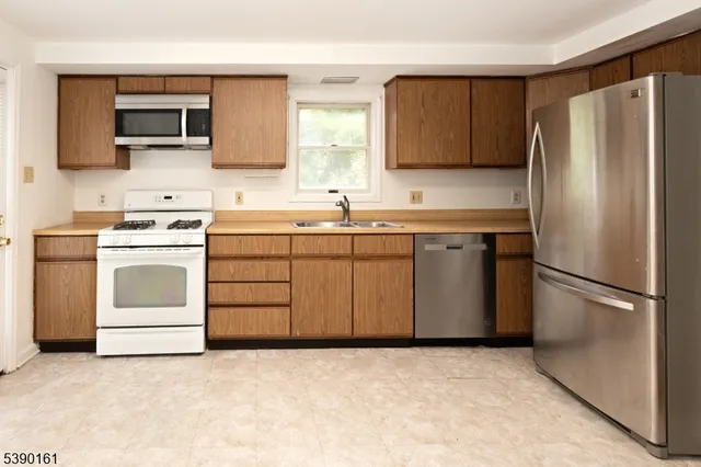 a kitchen with a stove sink and refrigerator