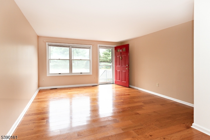 7 Emmet Avenue, Unit D Morristown, NJ 07960 - Photo 3 of 26 a view of an empty room with wooden floor and a window