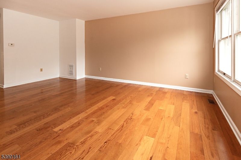7 Emmet Avenue, Unit D Morristown, NJ 07960 - Photo 4 of 26 an empty room with wooden floor and windows