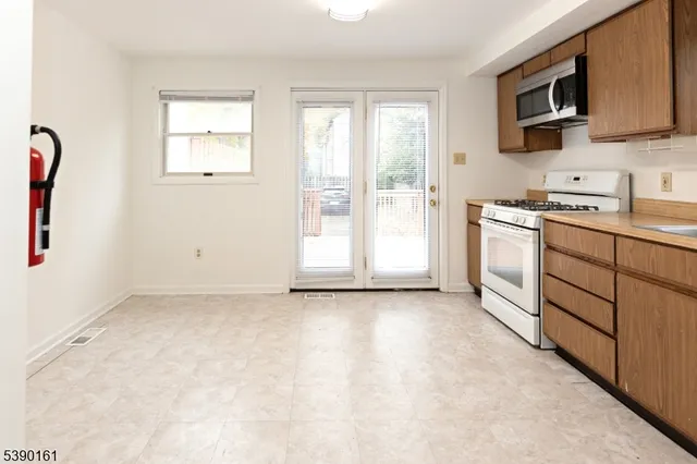 a view of a kitchen with electric appliances