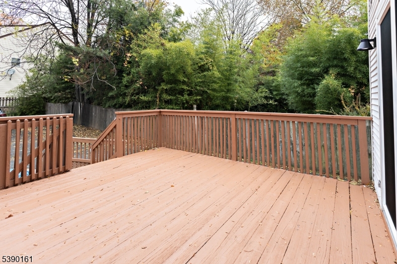 7 Emmet Avenue, Unit D Morristown, NJ 07960 - Photo 10 of 26 a balcony with wooden floor and fence