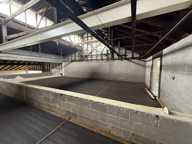 a view of a room with wooden floor and windows