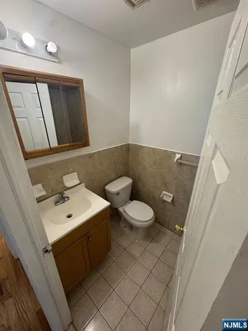 a bathroom with a sink a toilet and mirror