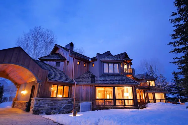 a kitchen with a sink stainless steel appliances and chandelier