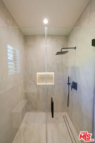 a bathroom with a tub and shower